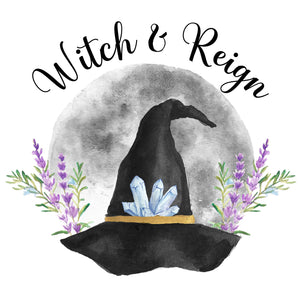 Witch & Reign logo in black font on top of a grey moon and black witch hat with crystals along the brim and lavender and rosemary branches on both sides of it. 